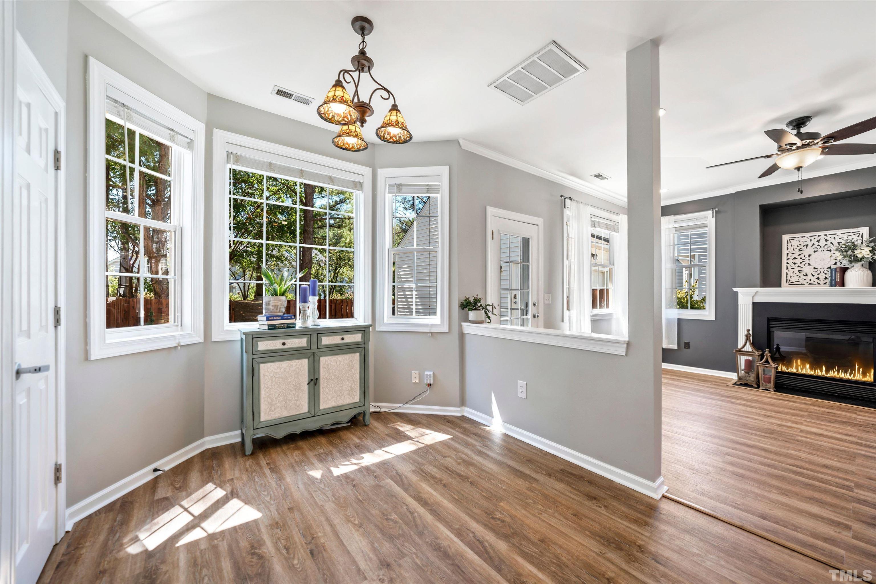 3012 White Cloud Circle Apex, NC 27502 - Photo 10 of 31 a view of livingroom with furniture wooden floor a flat screen tv and windows