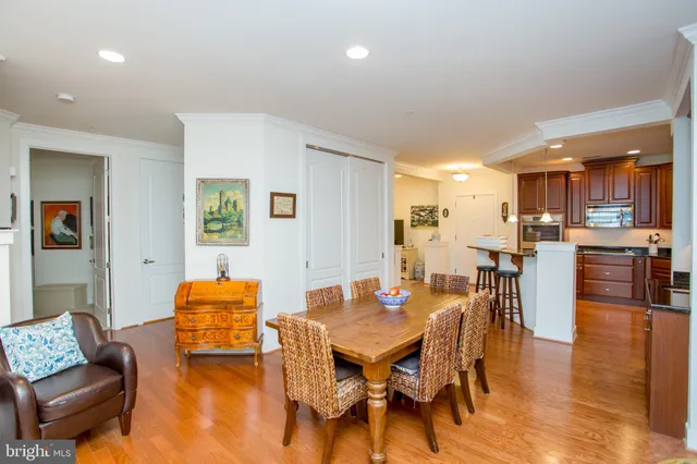 a living room with furniture and a dining table with kitchen view