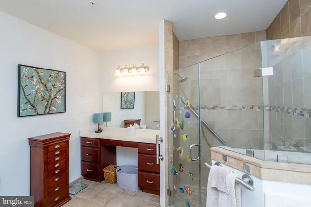 a bathroom with a sink a mirror and a shower