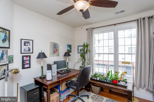 a living room with furniture cabinets and window