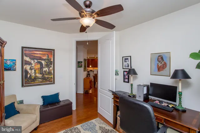 a living room with furniture and a bookshelf