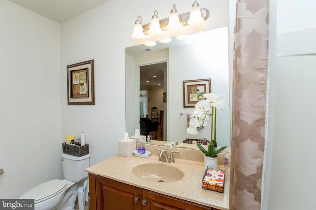 a front view of a building with large trees