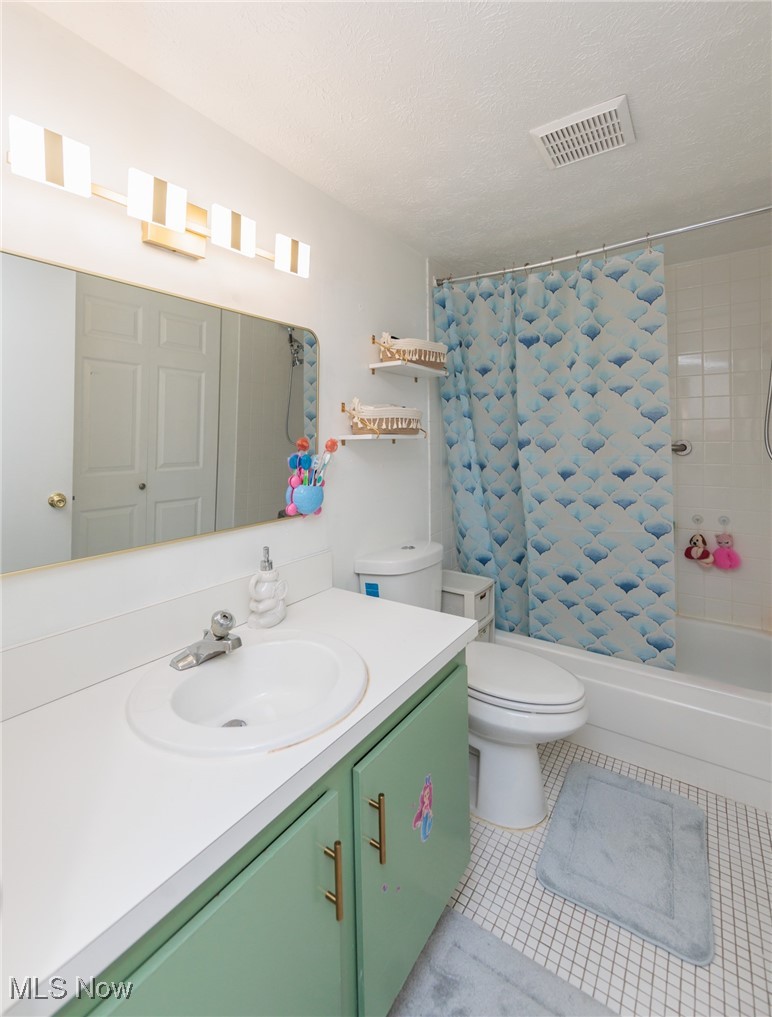 22958 Maple Ridge Road, Unit 209 North Olmsted, OH 44070 - Photo 29 of 38 Bathroom with light tile patterned flooring, shower / tub combo, a textured ceiling, and vanity