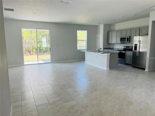 a view of a kitchen with furniture and a window