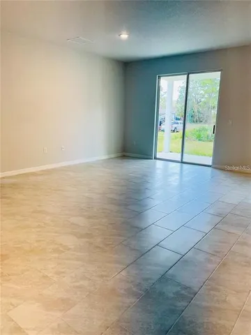 an empty room with natural light and window