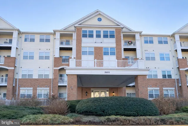 a front view of a building with a yard