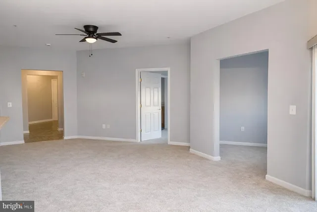 a view of an empty room with a fan