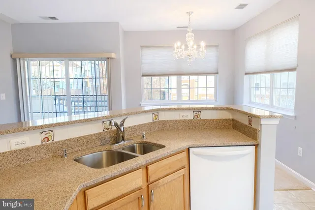 a kitchen with a sink and chandelier