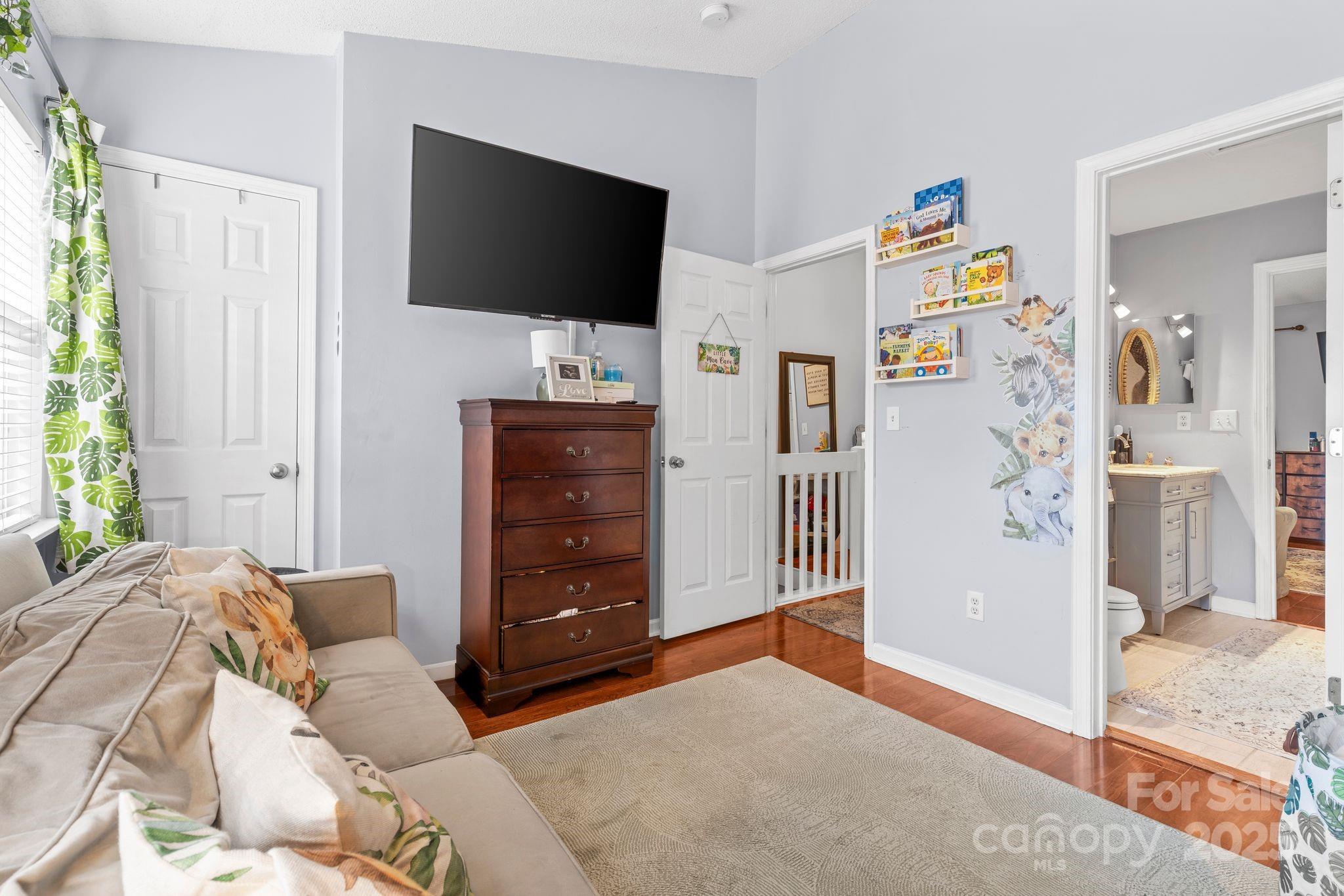 11643 Retriever Way Charlotte, NC 28269 - Photo 11 of 21 a living room with furniture and a flat screen tv