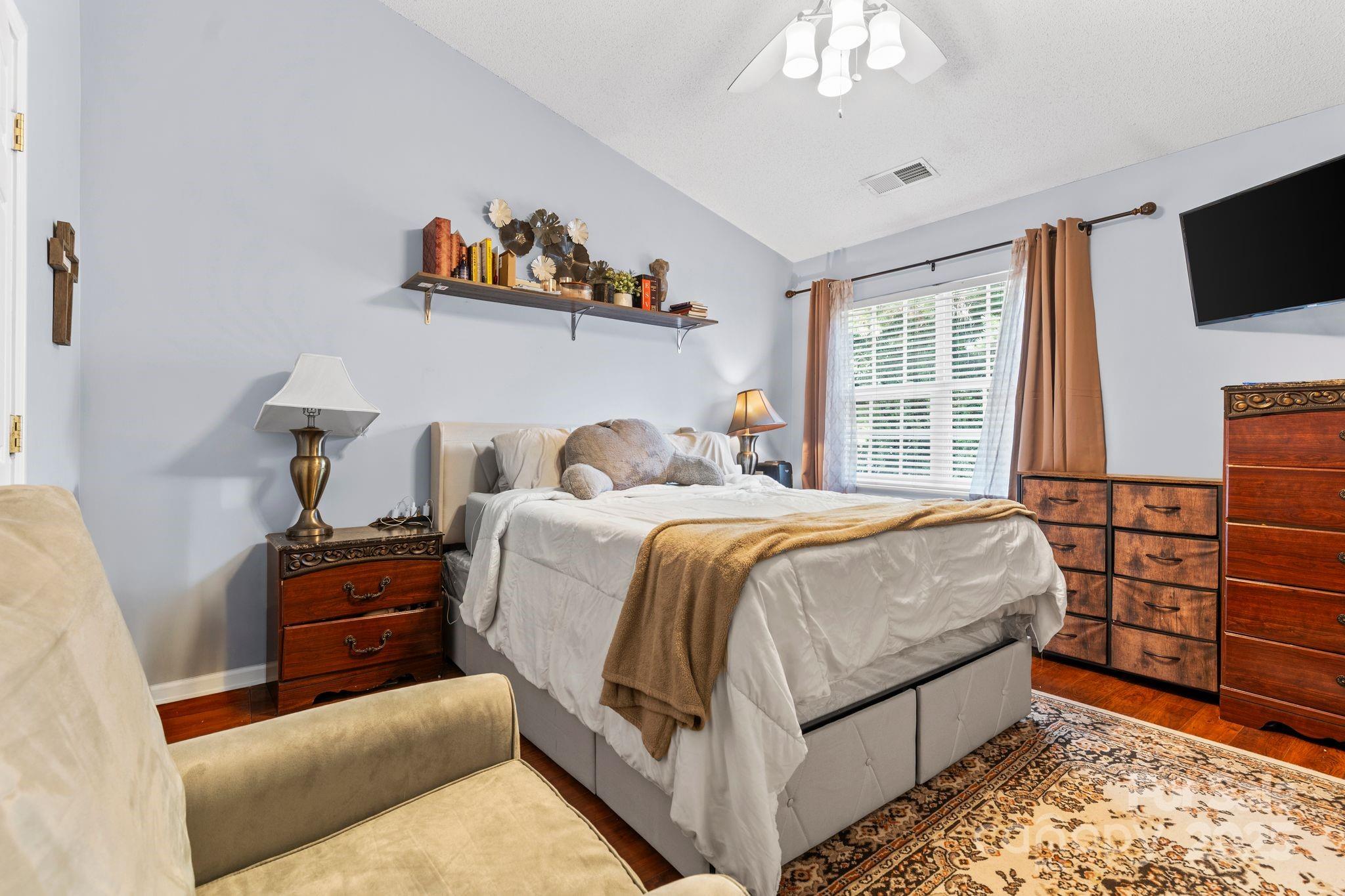 11643 Retriever Way Charlotte, NC 28269 - Photo 17 of 21 a bedroom with a bed and a television