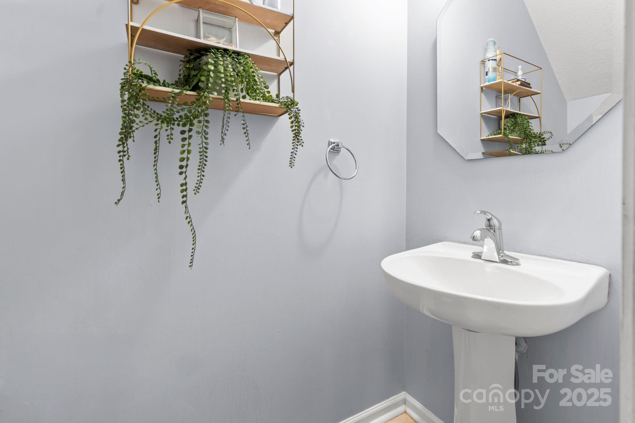 11643 Retriever Way Charlotte, NC 28269 - Photo 18 of 21 a bathroom with a sink and a mirror