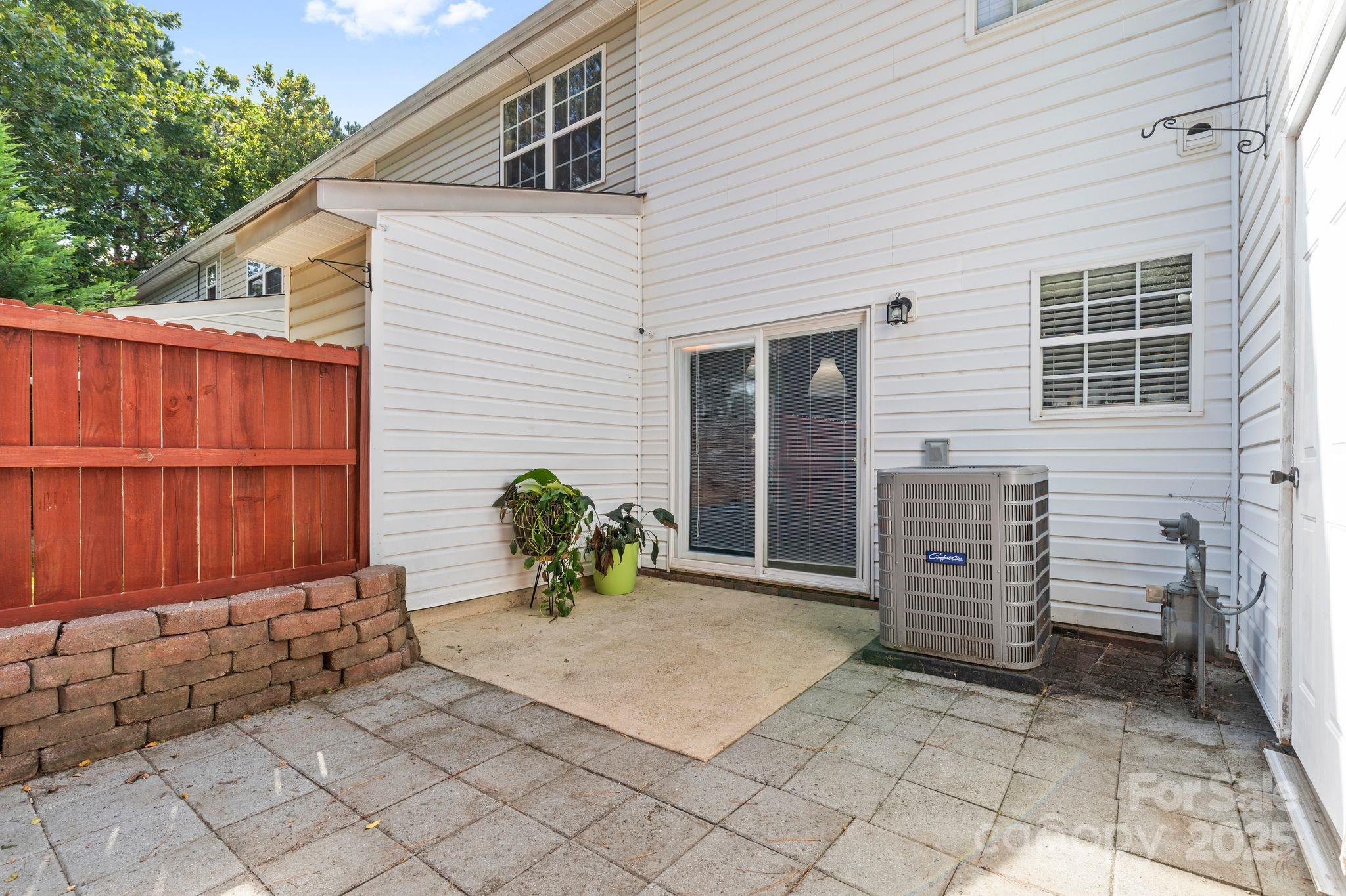 11643 Retriever Way Charlotte, NC 28269 - Photo 20 of 21 a view of backyard with a chair and potted plants