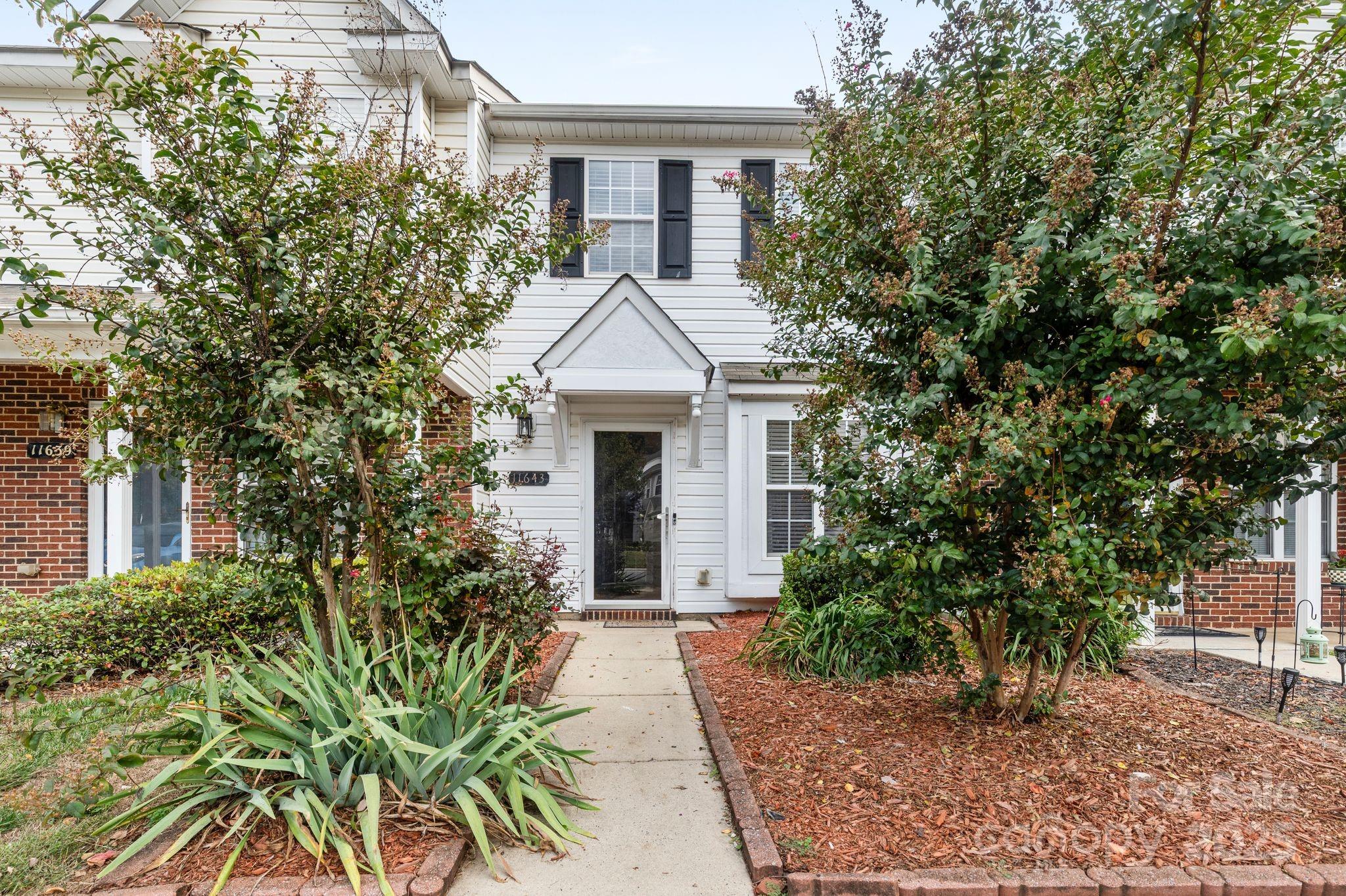 11643 Retriever Way Charlotte, NC 28269 - Photo 3 of 21 a front view of a house with garden