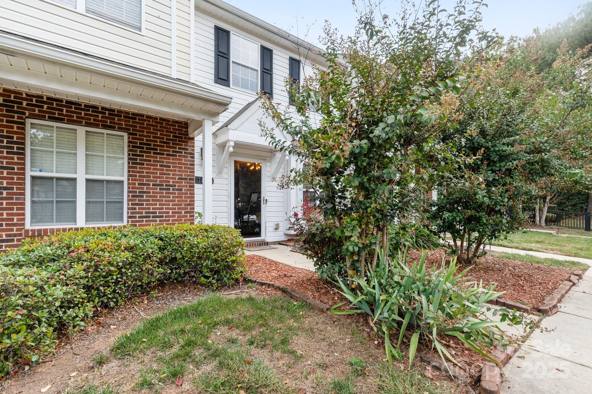 11643 Retriever Way Charlotte, NC 28269 - Photo 4 of 21 a front view of a house with garden