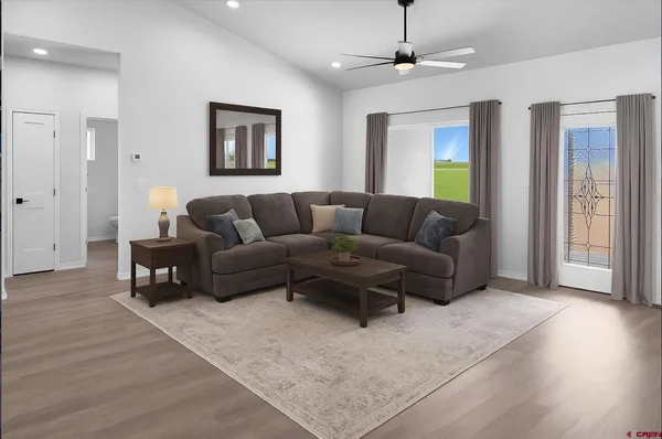a living room with furniture and a wooden floor