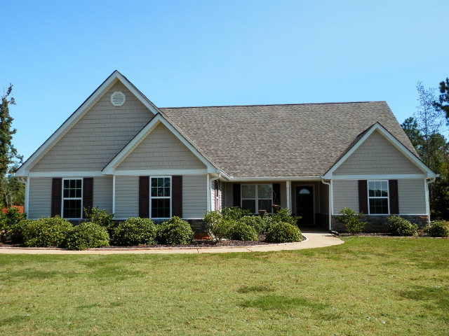 a front view of house with yard and green space