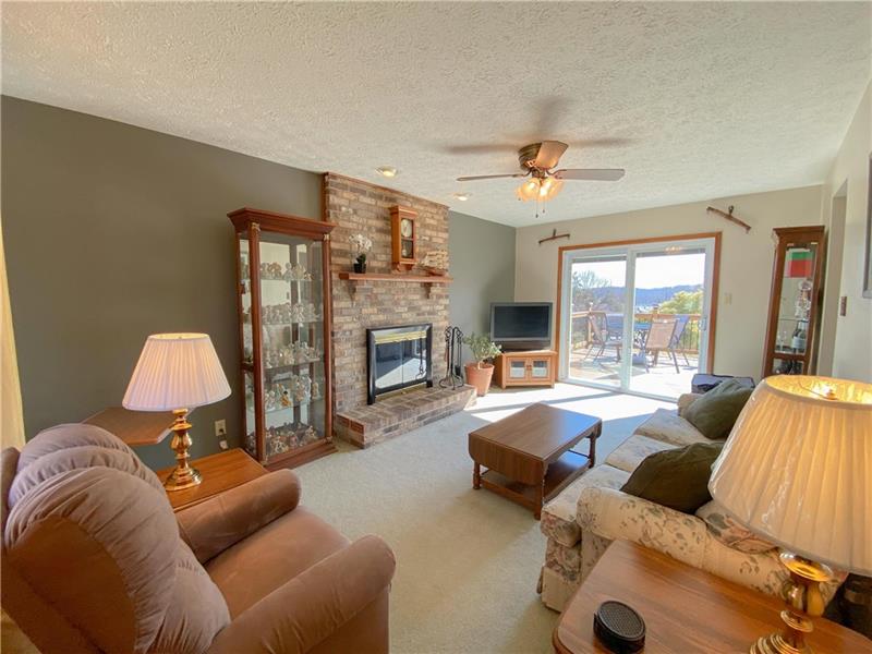 6 Hickory Grade Road Cecil, PA 15321 - Photo 4 of 25 Family room to the Left of the Entry has a brick wood burning fireplace and new sliding door for a beautiful view out onto the Deck.