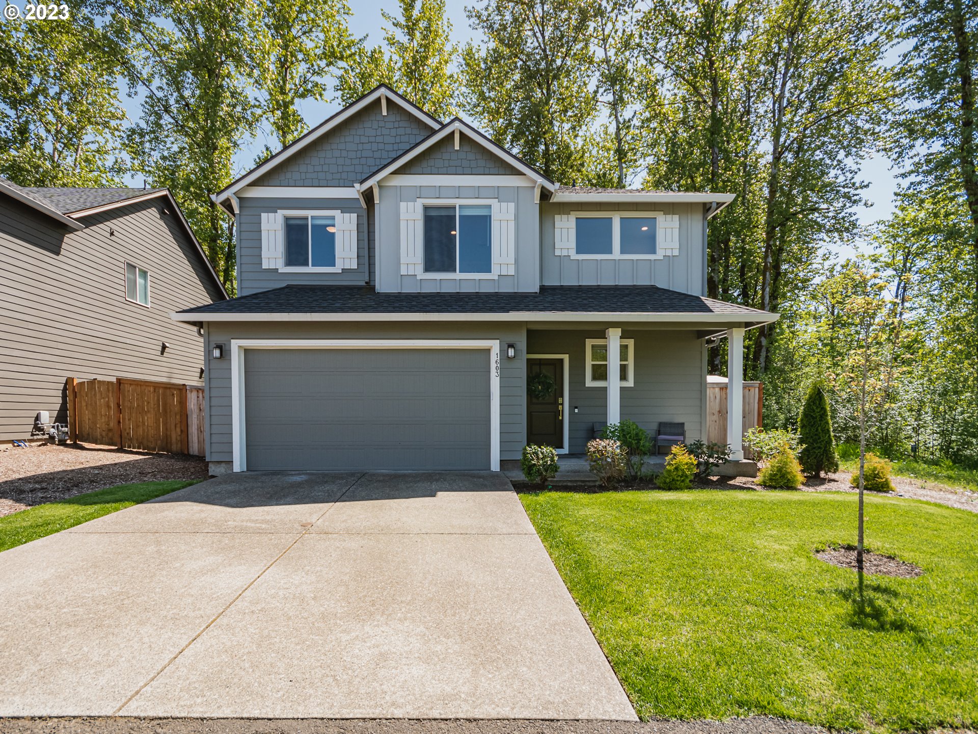1603 Northeast 170th Circle Ridgefield, WA 98642 - Photo 1 of 23 a front view of a house with a yard and trees