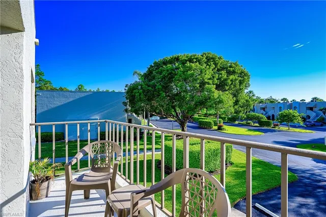 a view of a chair and tables in the balcony