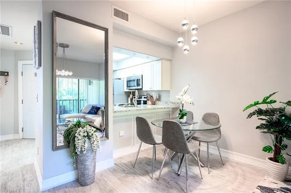a view of a dining room with furniture and a potted plant