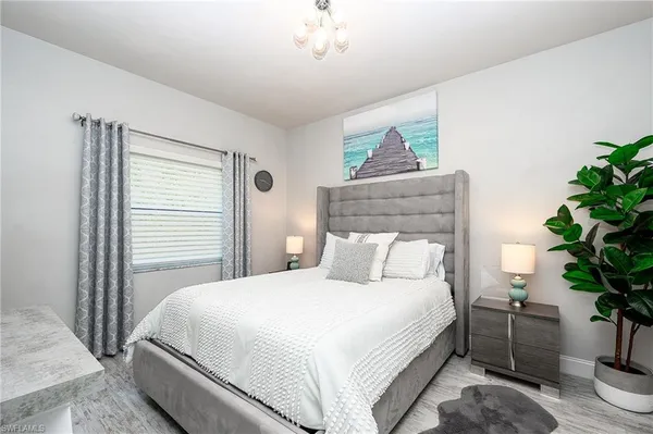 a bedroom with a bed and a potted plant