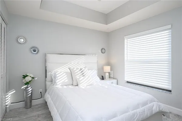 a bedroom with a bed and a potted plant