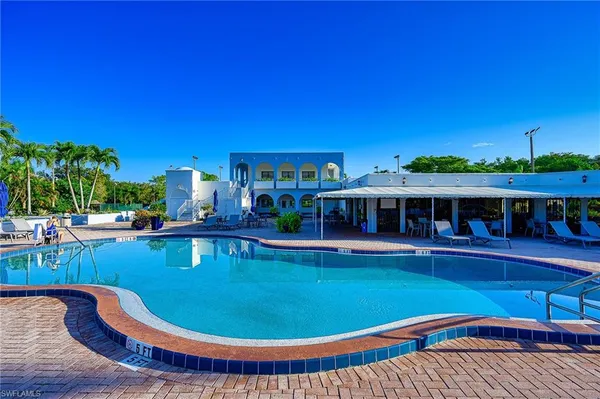 a view of a swimming pool with lounge chairs