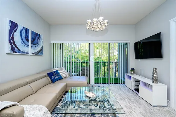 a living room with furniture tv and a window