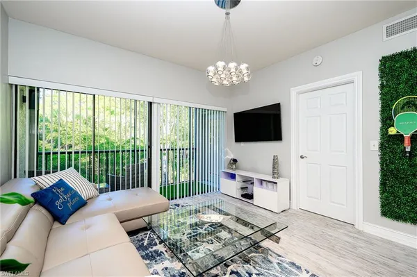 a spacious bedroom with a bed and a flat screen tv