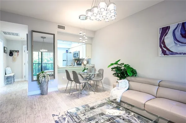a living room with furniture and a chandelier