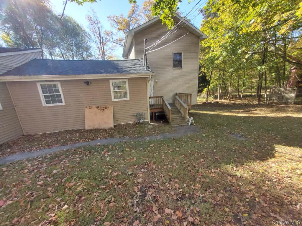 422 Spring Street Monroe, NY 10950 - Photo 1 of 1 Rear view of property featuring a wooden deck and a lawn