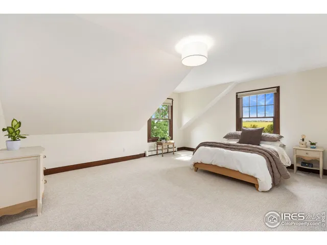 a spacious bedroom with a bed and a window