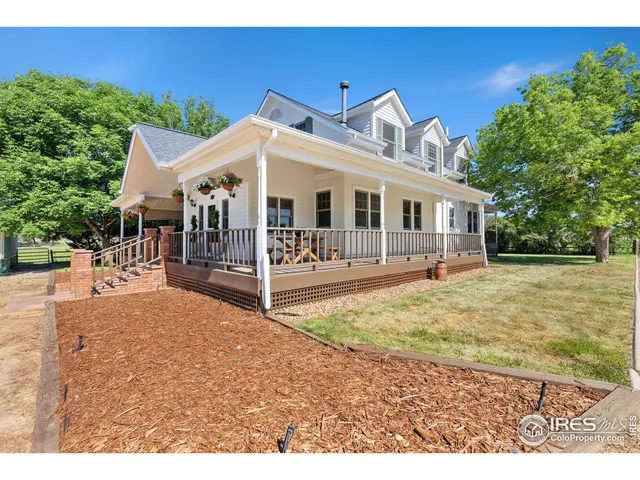 a front view of a house with a yard outdoor seating and garage