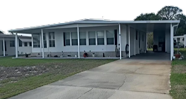 a view of house with backyard