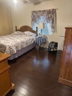 1211 Apache Circle Tavares, FL 32778 - Photo 7 of 9 a bedroom with a bed and a night stand