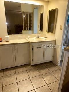 1211 Apache Circle Tavares, FL 32778 - Photo 8 of 9 a bathroom with a sink vanity and a mirror