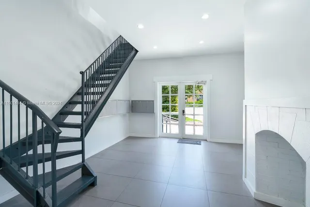 a view of entryway with wooden floor and stairs