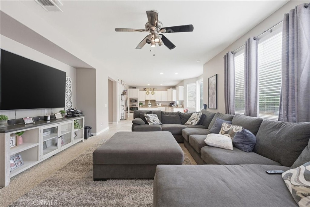 34326 Heather Ridge Road Lake Elsinore, CA 92532 - Photo 13 of 46 a living room with furniture and a flat screen tv