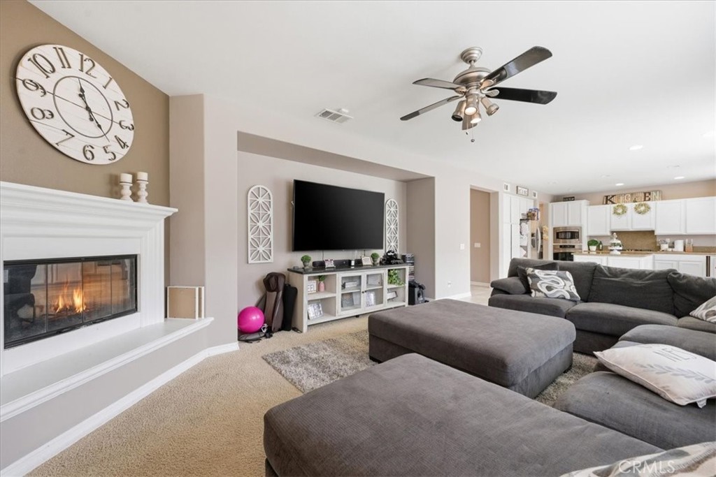 34326 Heather Ridge Road Lake Elsinore, CA 92532 - Photo 16 of 46 a living room with furniture and a flat screen tv