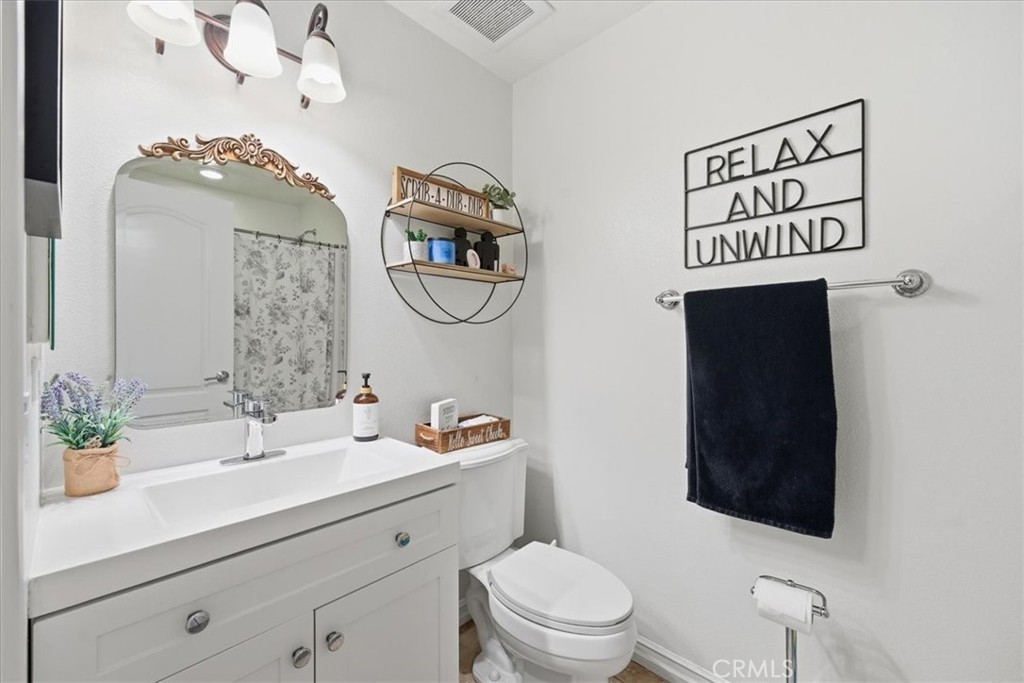 34326 Heather Ridge Road Lake Elsinore, CA 92532 - Photo 19 of 46 a bathroom with a toilet sink and mirror