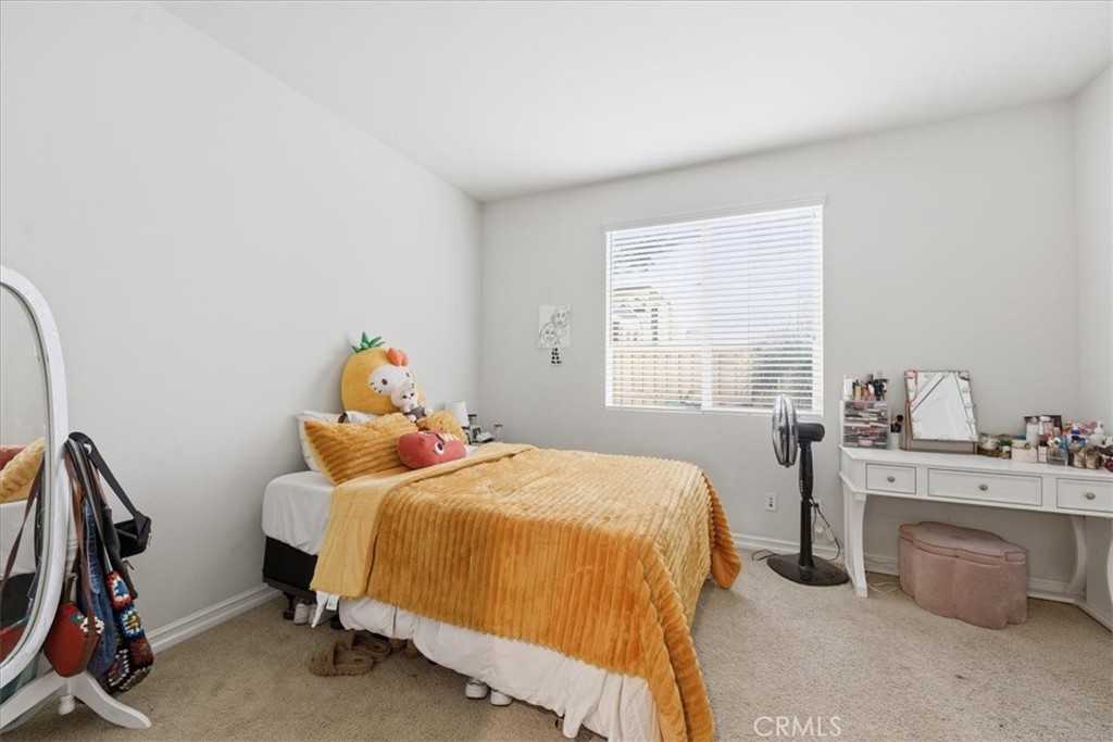 34326 Heather Ridge Road Lake Elsinore, CA 92532 - Photo 20 of 46 a bedroom with a bed and a window