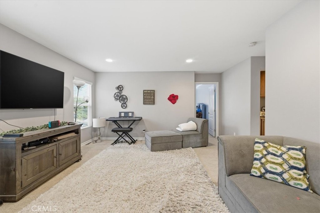 34326 Heather Ridge Road Lake Elsinore, CA 92532 - Photo 22 of 46 a living room with furniture and a flat screen tv
