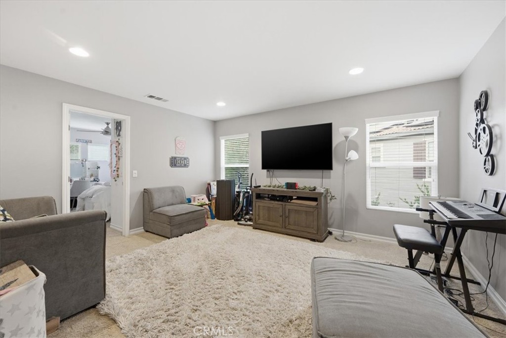 34326 Heather Ridge Road Lake Elsinore, CA 92532 - Photo 23 of 46 a living room with furniture and a flat screen tv