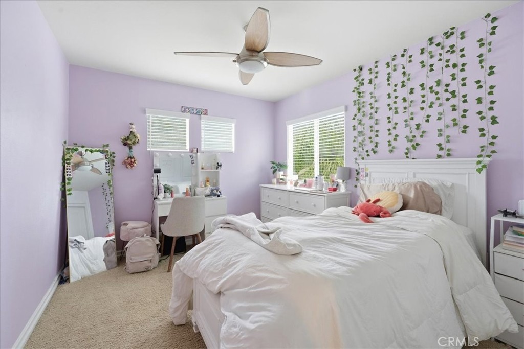 34326 Heather Ridge Road Lake Elsinore, CA 92532 - Photo 24 of 46 a bedroom with a bed and a window