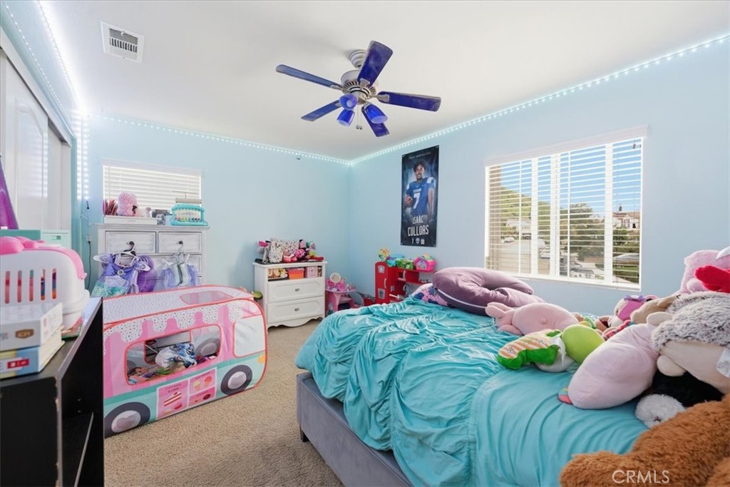 34326 Heather Ridge Road Lake Elsinore, CA 92532 - Photo 25 of 46 a bedroom with bed and a window