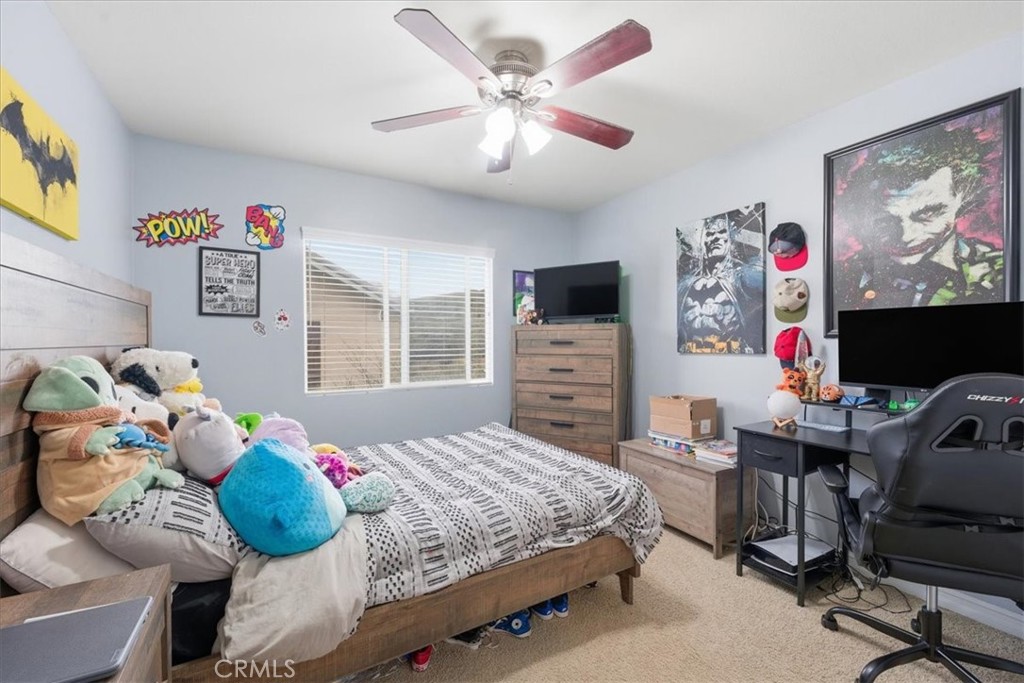 34326 Heather Ridge Road Lake Elsinore, CA 92532 - Photo 26 of 46 a bedroom with a bed and a flat screen tv