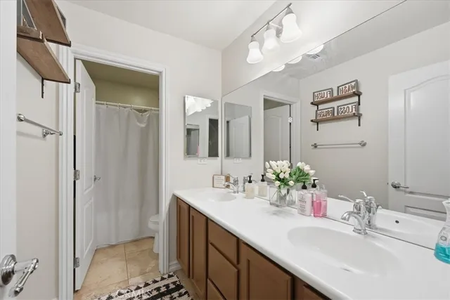 a bathroom with a sink a shower and a mirror