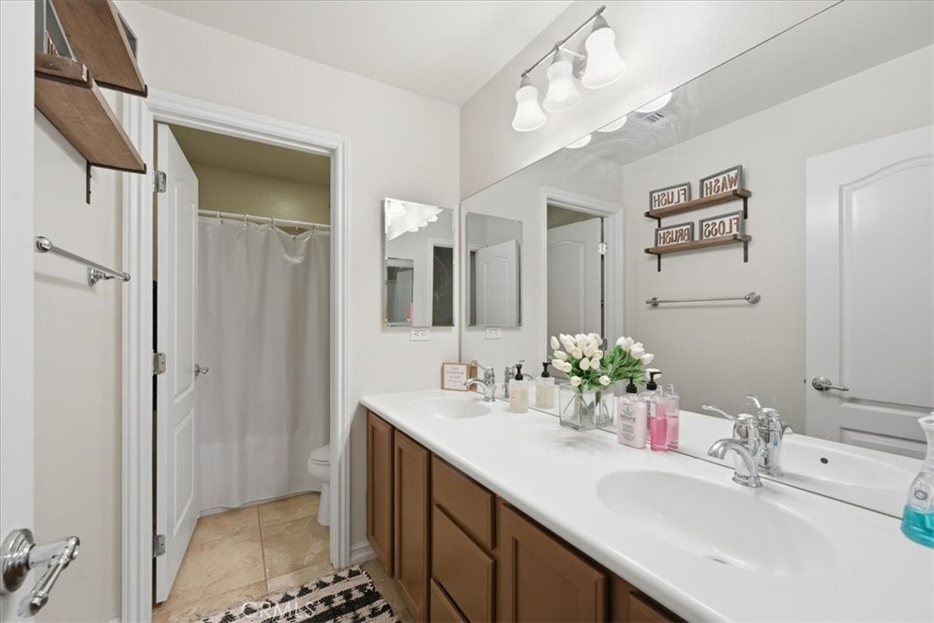 34326 Heather Ridge Road Lake Elsinore, CA 92532 - Photo 28 of 46 a bathroom with a sink a shower and a mirror