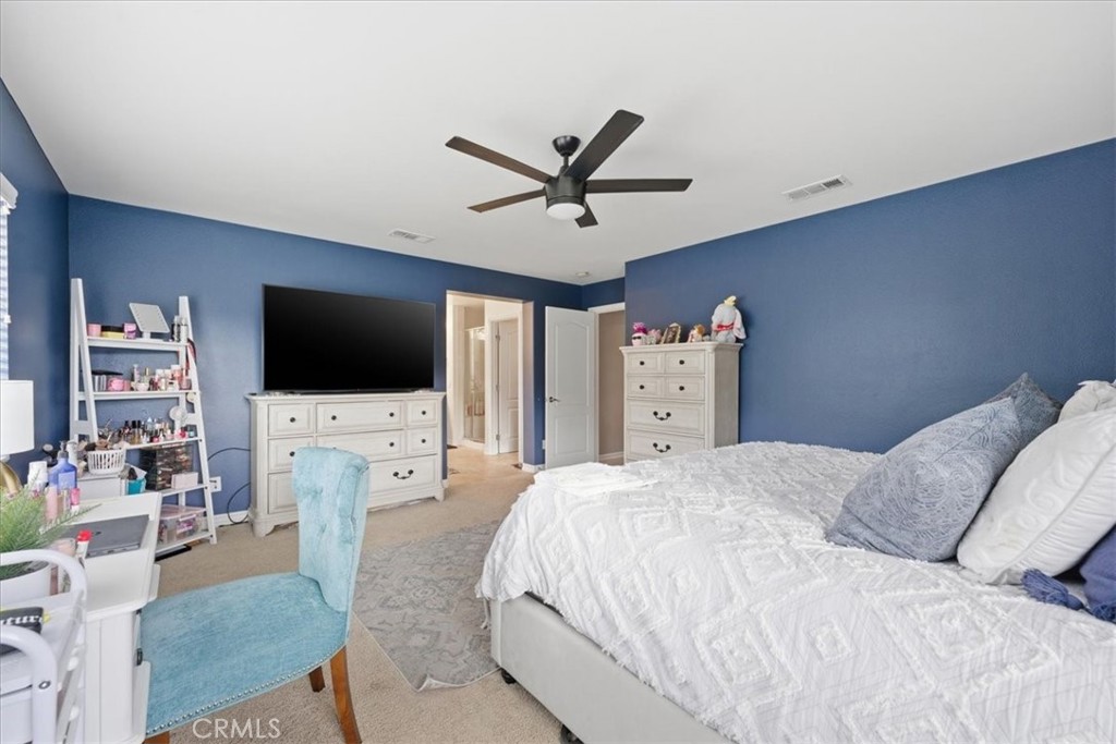 34326 Heather Ridge Road Lake Elsinore, CA 92532 - Photo 29 of 46 a bedroom with a flat screen tv on the dresser and a flat screen tv