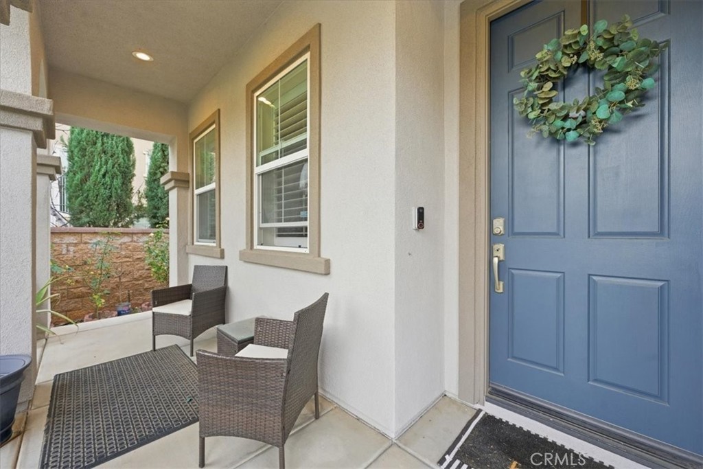 34326 Heather Ridge Road Lake Elsinore, CA 92532 - Photo 3 of 46 a living room with furniture and a potted plant